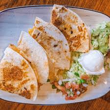 La Fogata signature dishes Chicken Breast FajitasGrilled Quesadilla SupremeCarne Adobada﻿﻿